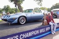 Sam Burns with the trophy and the 1979 Dodgers Challenger he received as the winner of the 2022 Charles Schwab Challenge (Image via Getty).